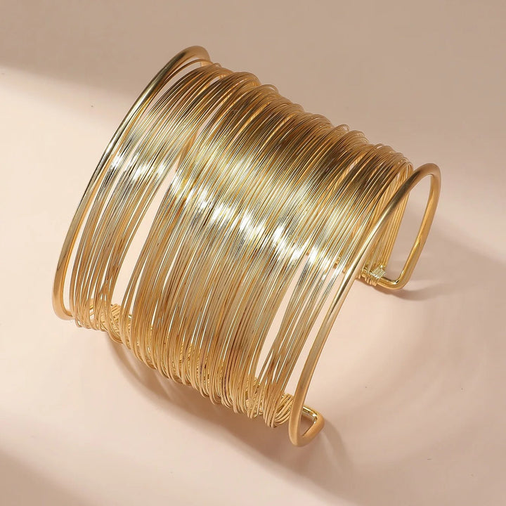 Braccialetto aperto in oro con design a spirale